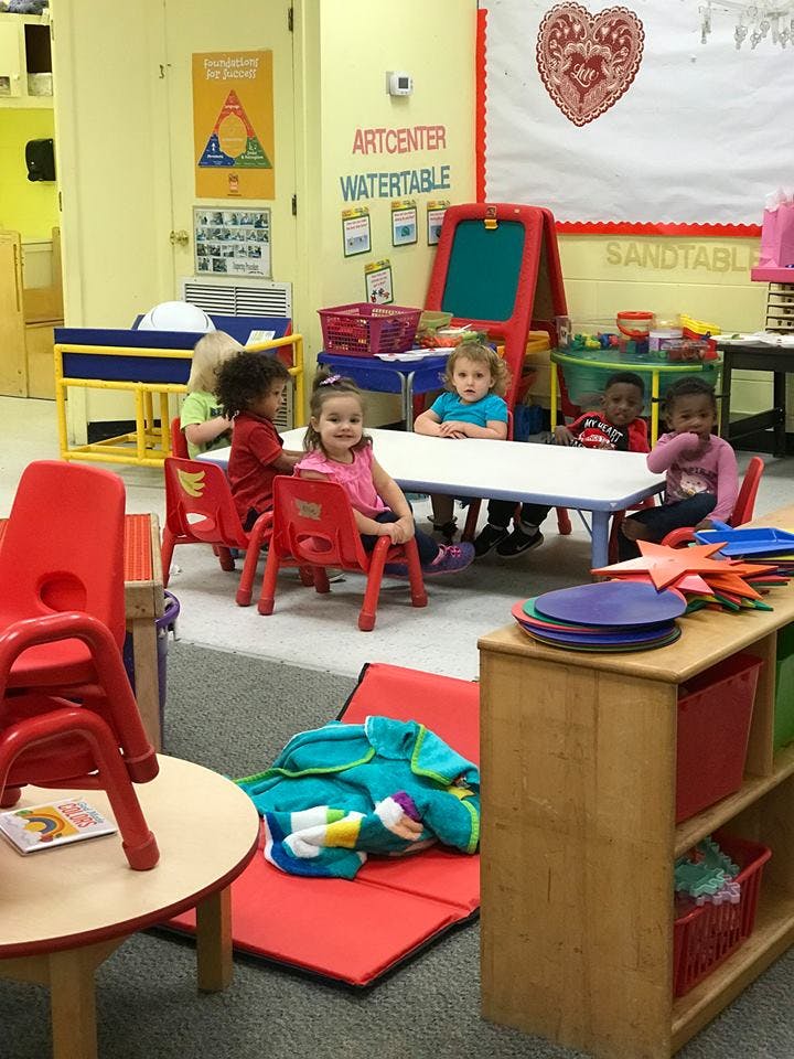 Children sitting at a table in a classroom