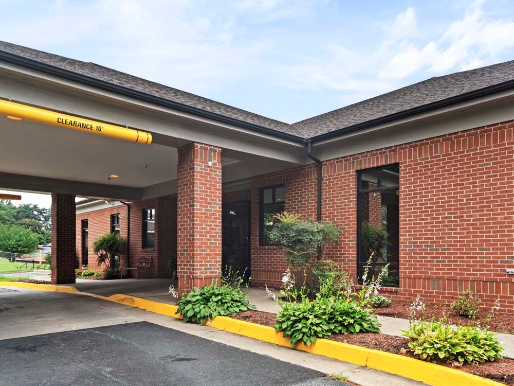 Brick building with a drive-through entrance and yellow clearance bar