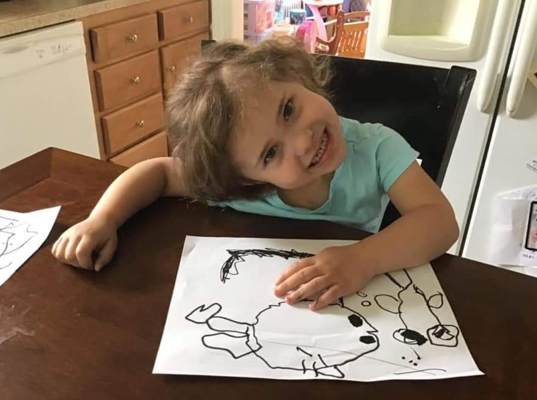 Child coloring at a table