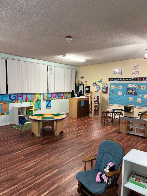 Classroom with small tables, chairs, and alphabet decorations