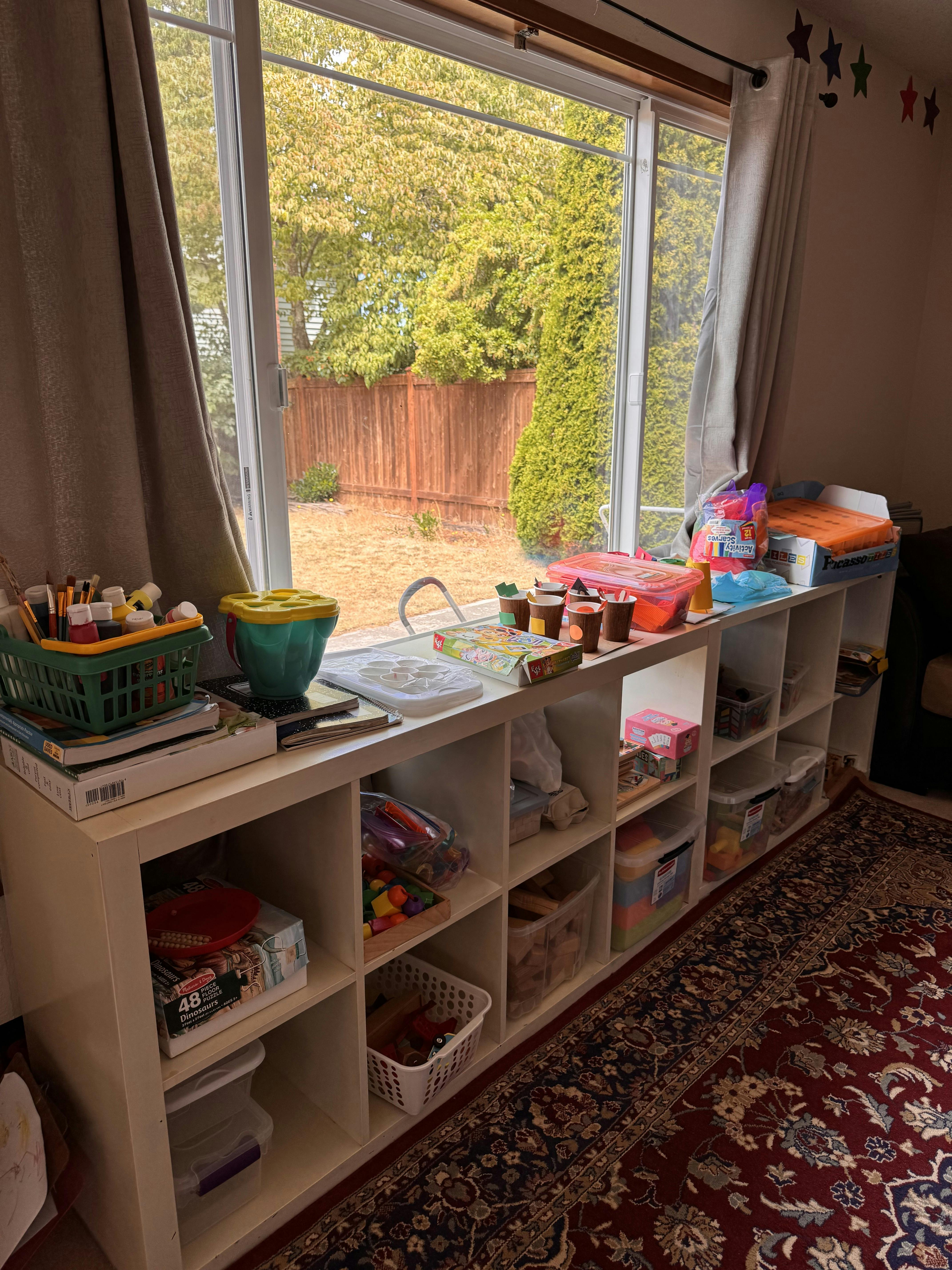 Craft supplies on a white storage unit in front of a window