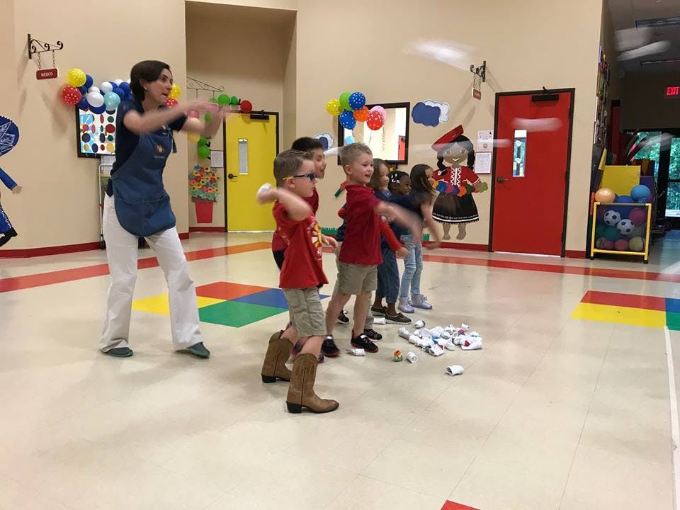 Adult and children playing a game indoors