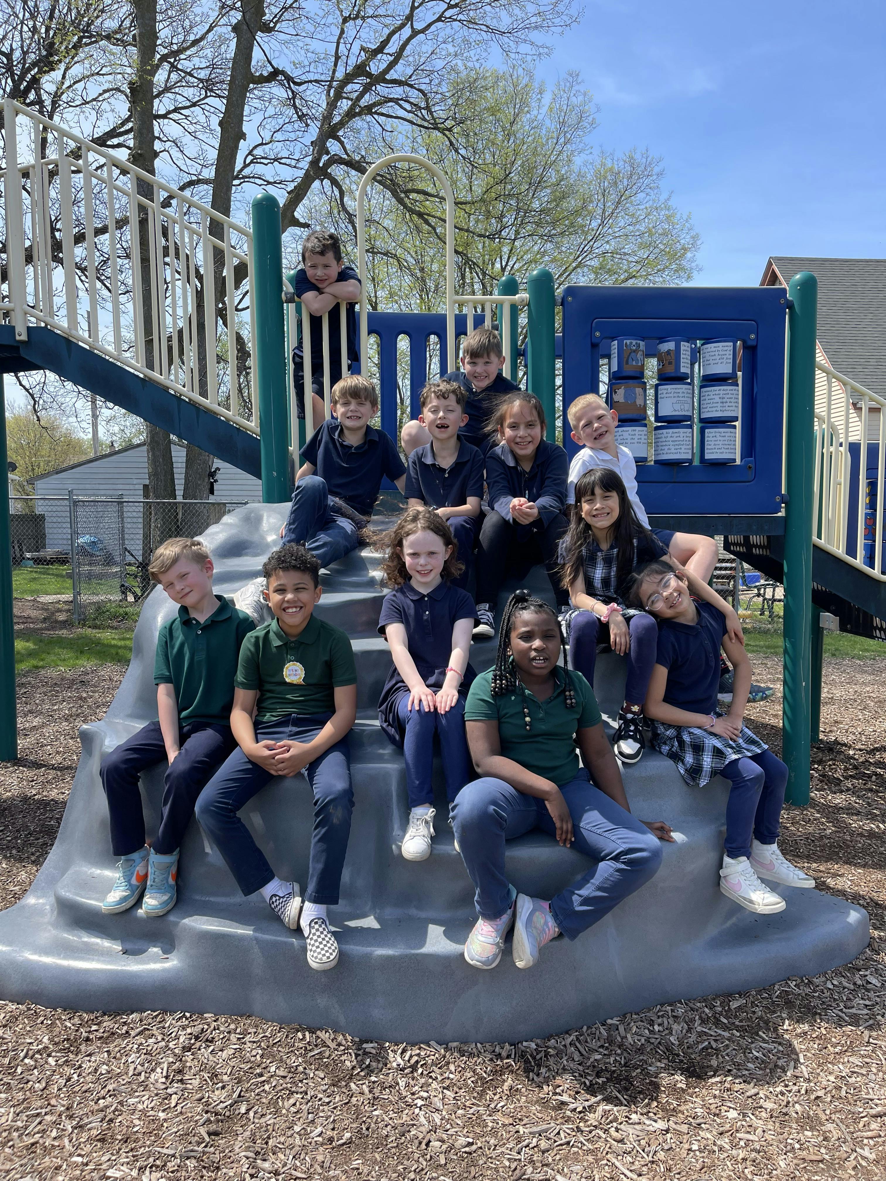 Group of children posing on playground equipment