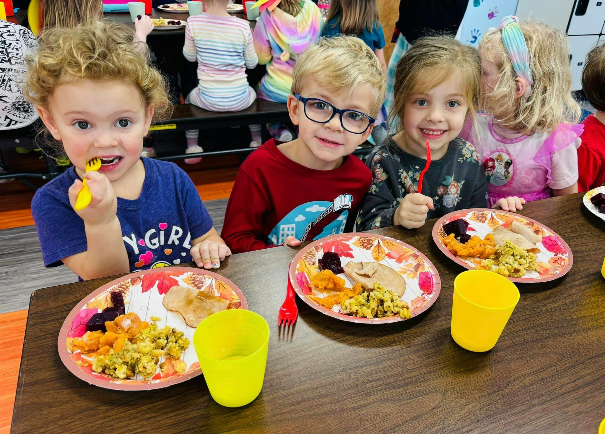 Three children eating at a table