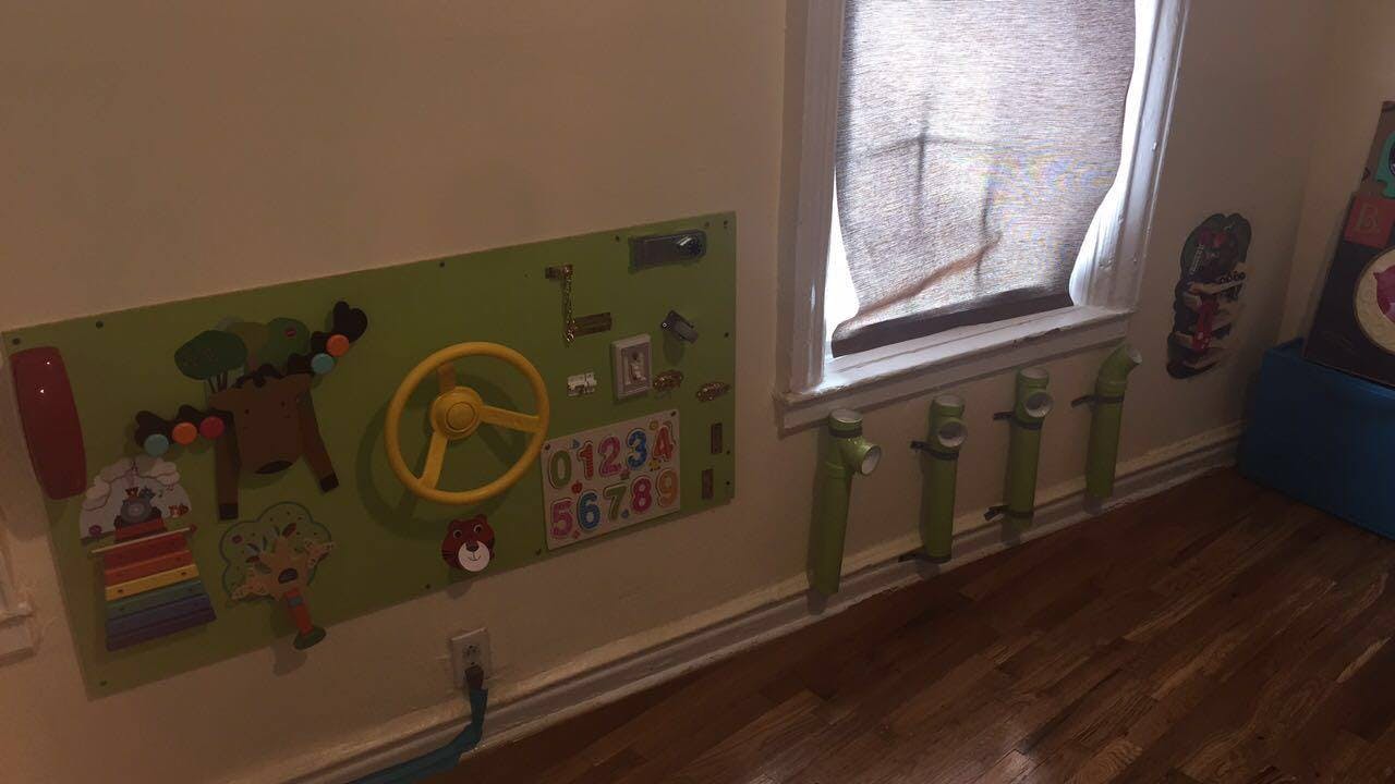 Activity board with a steering wheel and numbers on a wall