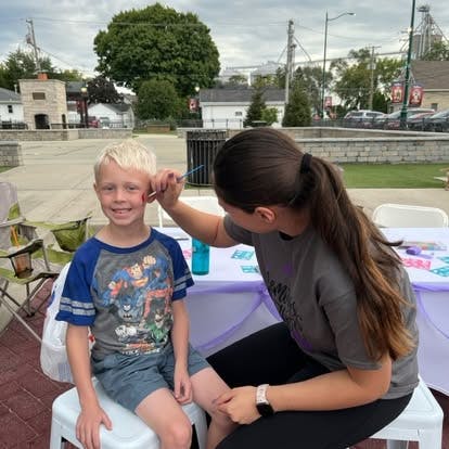 Person painting a child's face