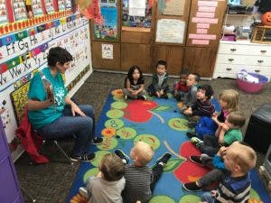 Person reading to children in a classroom