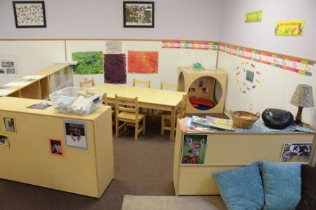 Empty classroom with small tables and chairs