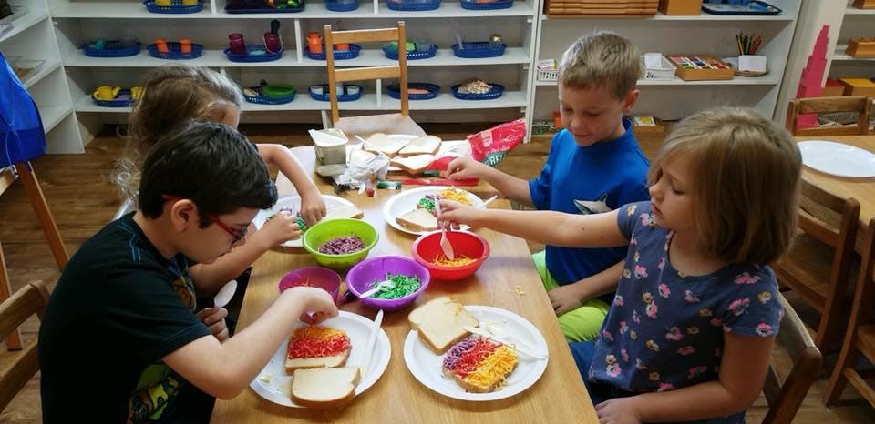 Children making food at a table