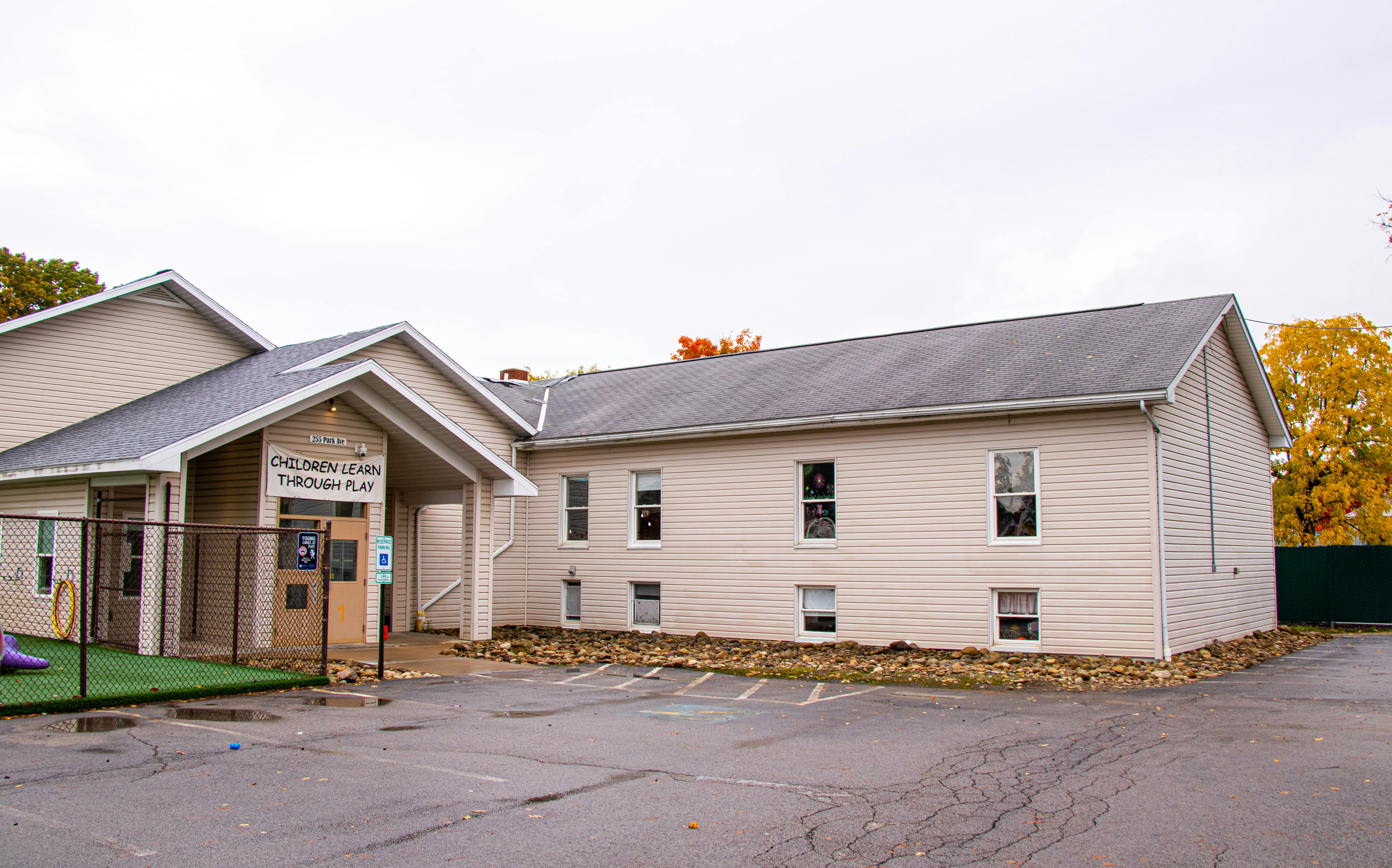 Building with a covered entrance and a parking lot