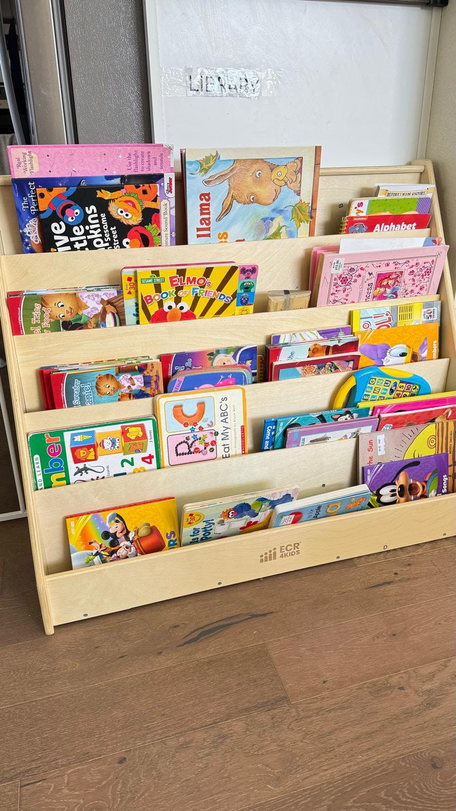 Wooden bookshelf filled with children's books