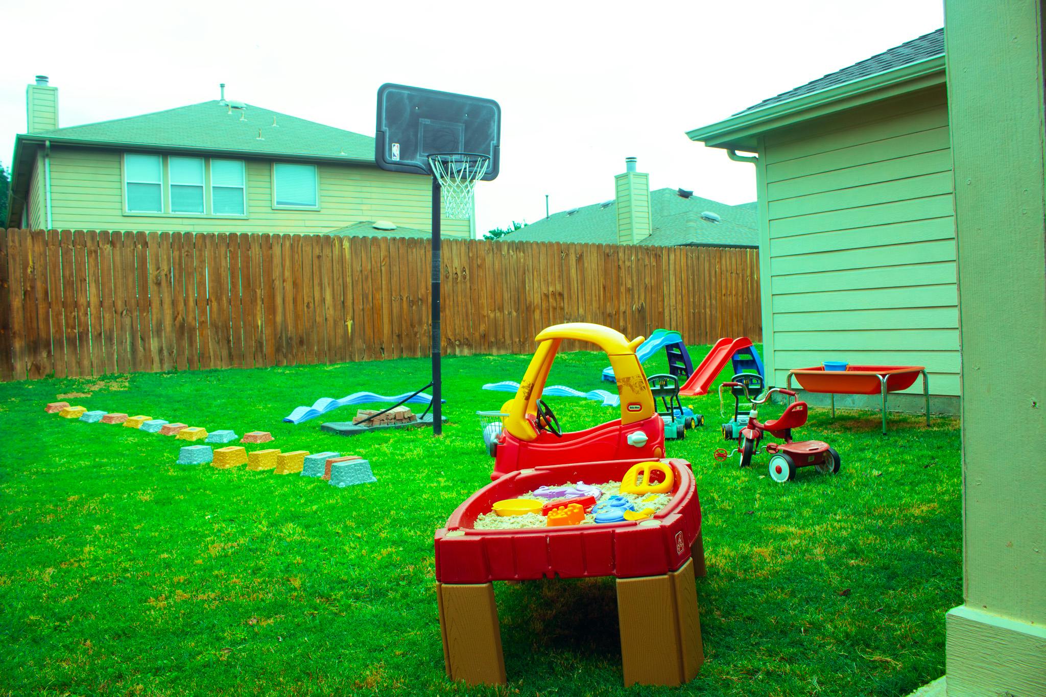 backyard with a variety of children's play equipment