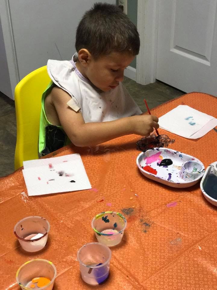 Child painting at a table