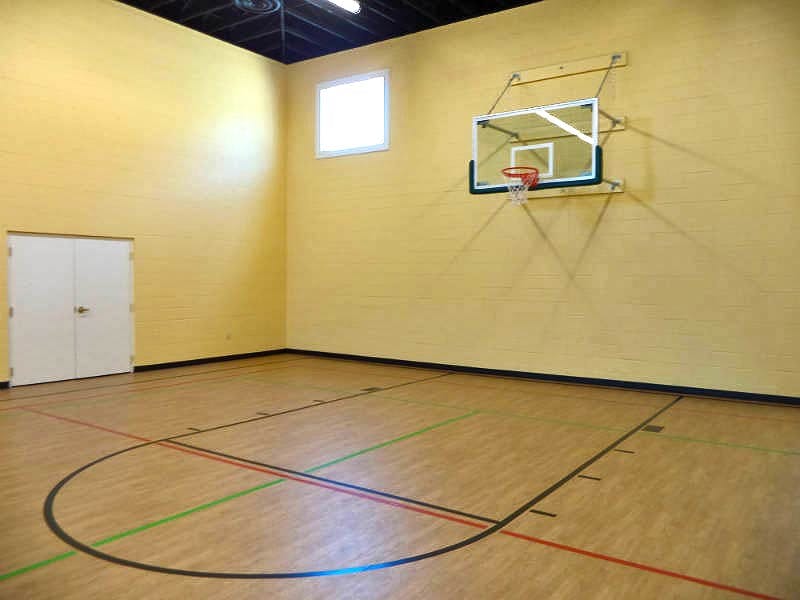 Indoor basketball court with a hoop and marked floor