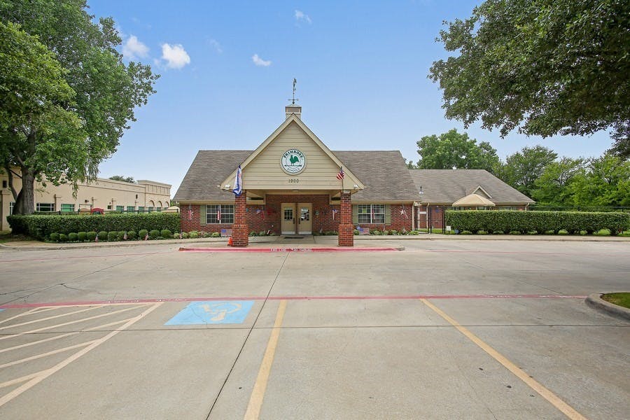 Building with a gabled entrance and a parking lot in front