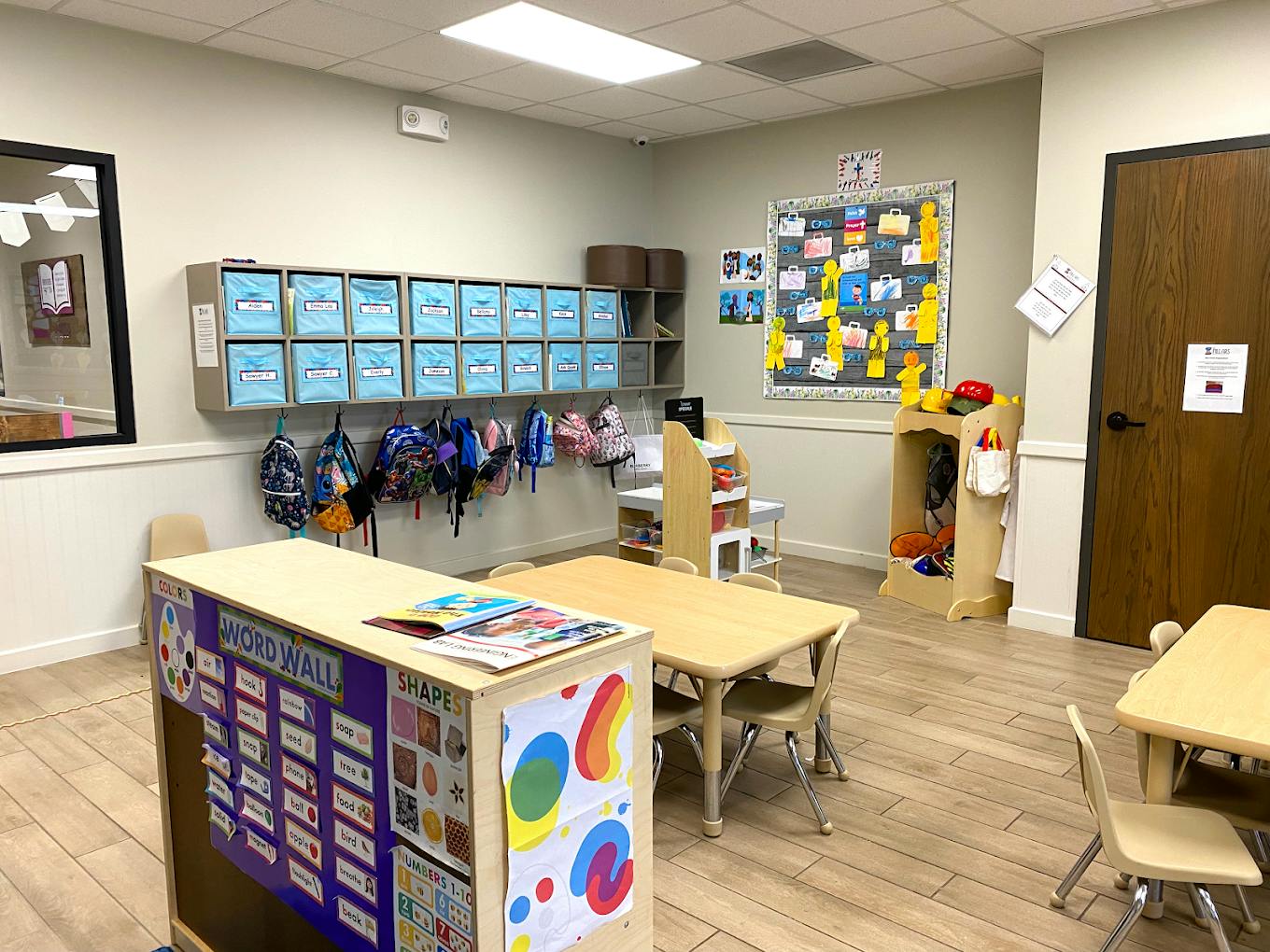 Classroom with child-sized tables chairs and colorful educational wall displays