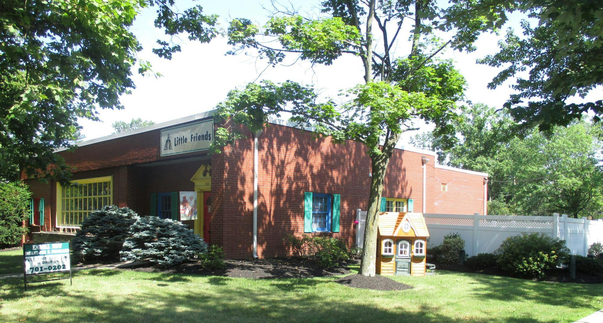 Building with a sign that says "Little Friends"