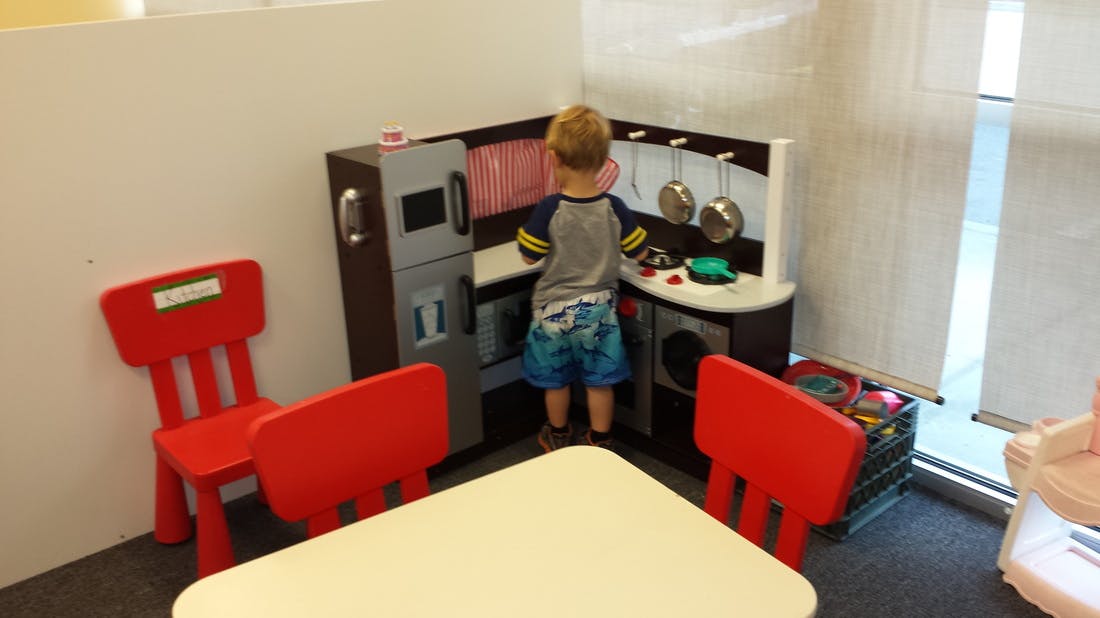 Child playing in a toy kitchen