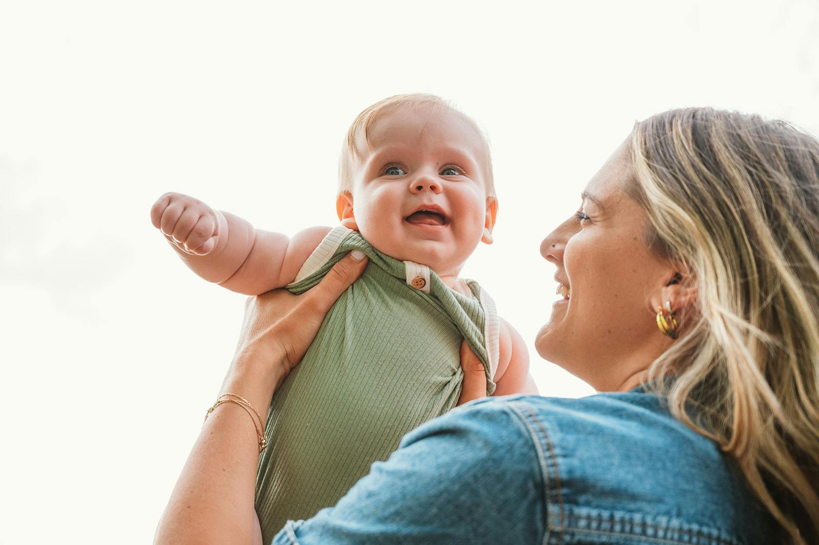 Person holding a child up in the air