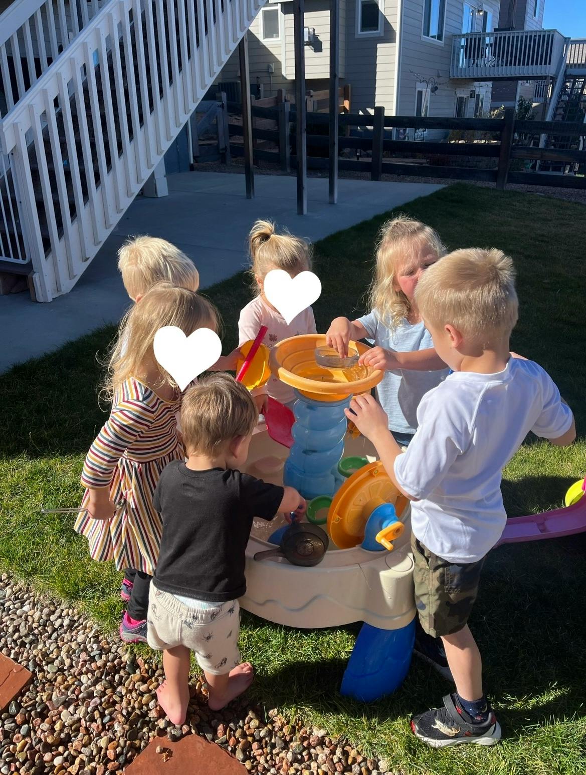 Children playing with a water table outdoors