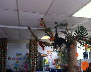 Classroom with a large decorative tree and colorful curtains