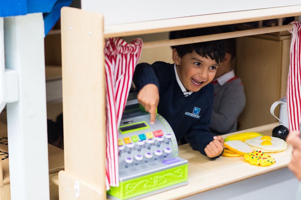 Child playing with a toy cash register