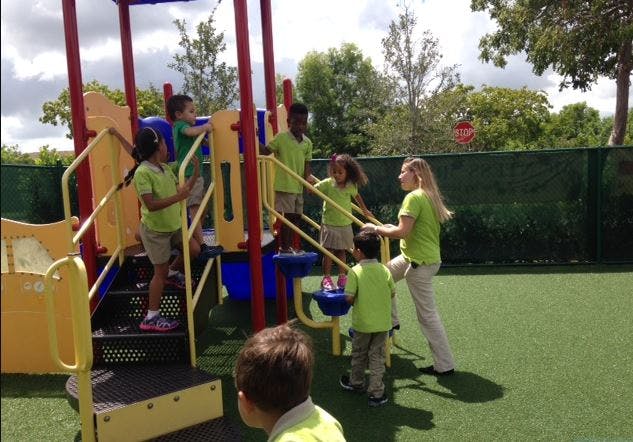 Adult and children on a playground structure