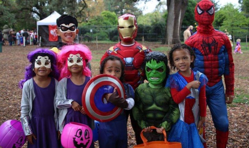 Children and adults in superhero costumes