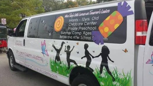 White van with colorful decals of children playing and text