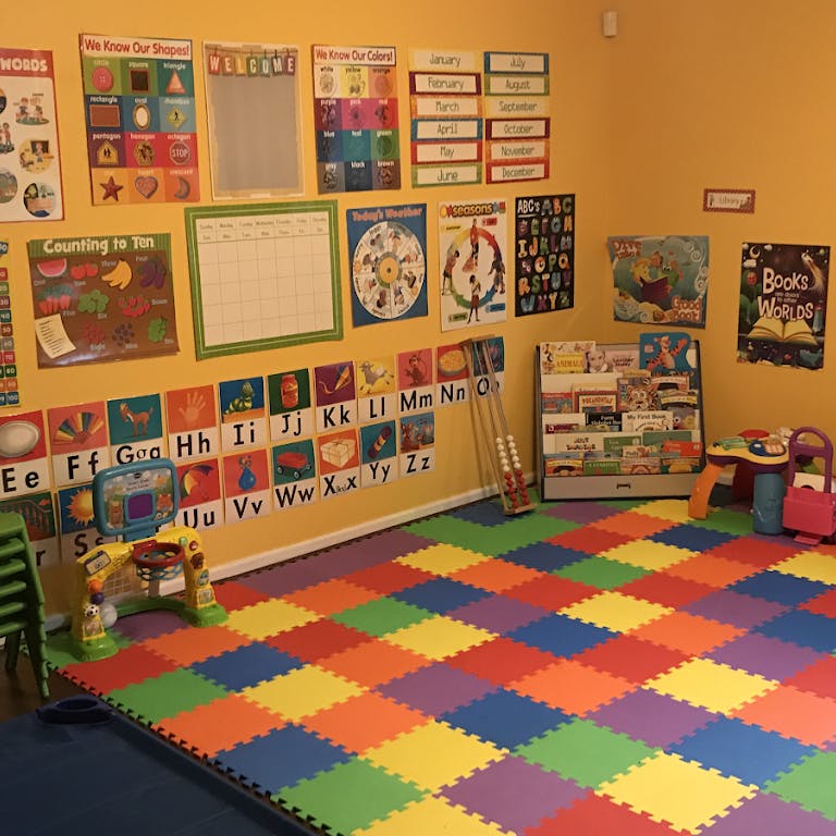 Classroom with colorful floor mats and educational posters on the wall