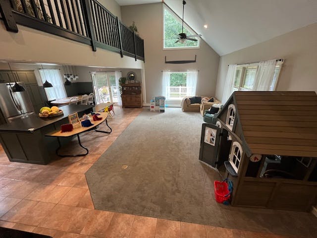 Open concept living space with kitchen, living room, and playhouse