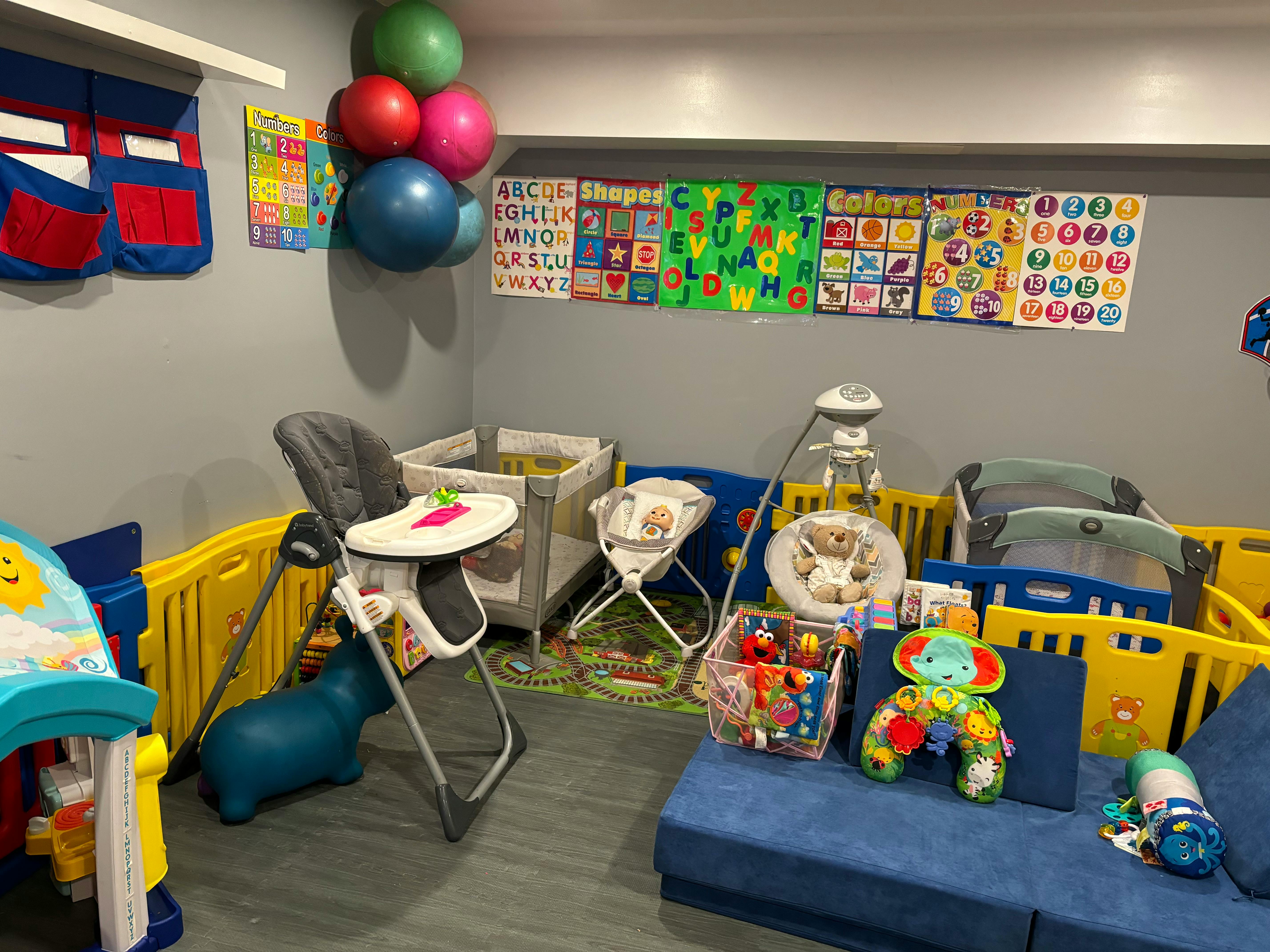 A room with baby cribs, high chairs, and playpens