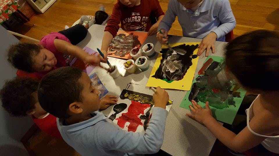 Children painting at a table