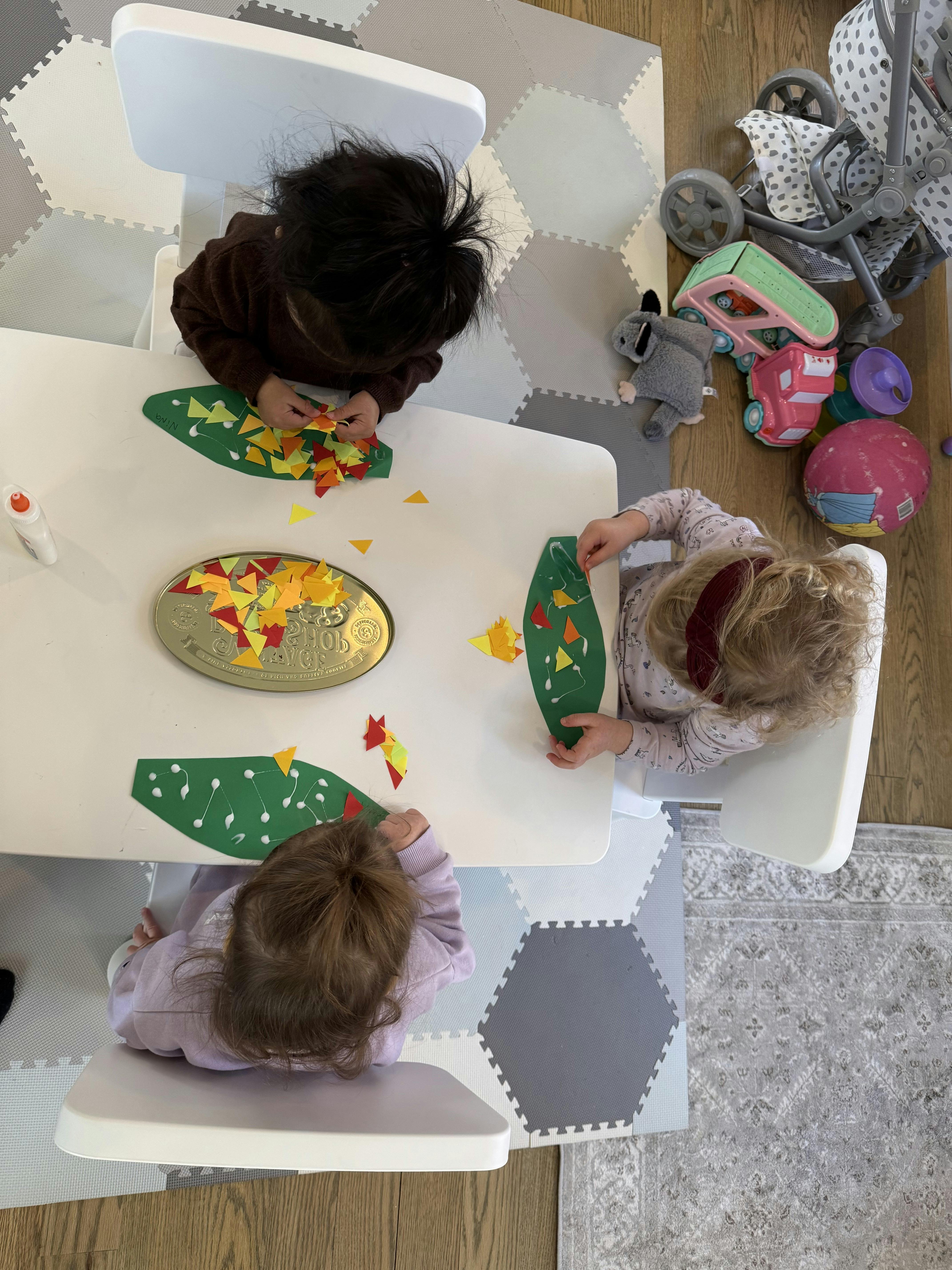 Three children doing crafts at a table