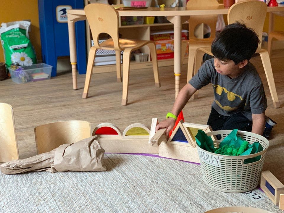 Child playing with wooden blocks on the floor