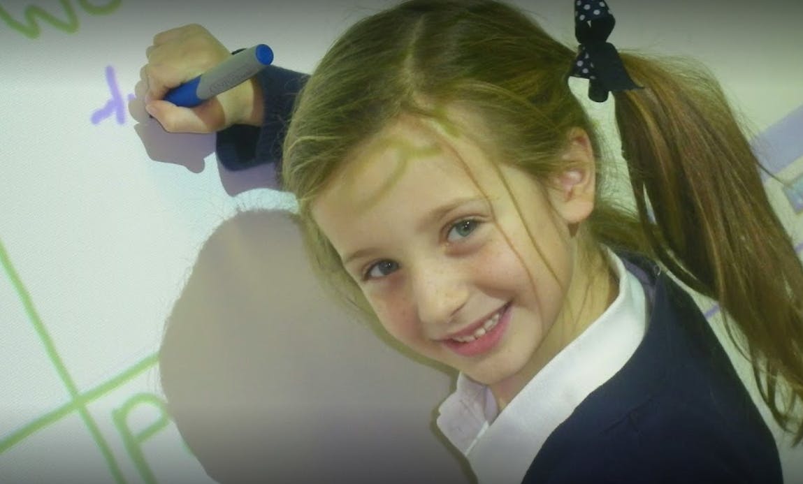 Child writing on a whiteboard