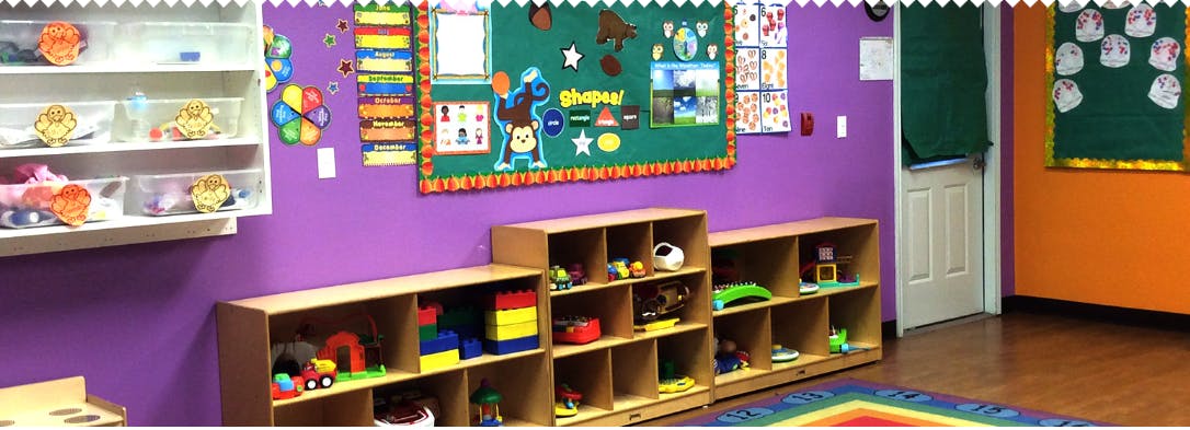 Classroom with purple walls, cubbies, and bulletin boards