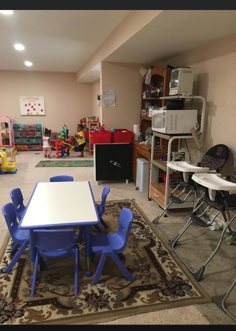 Children playing in a room with a small table and chairs