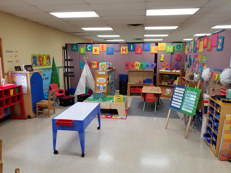 Preschool classroom with colorful decorations and various learning stations