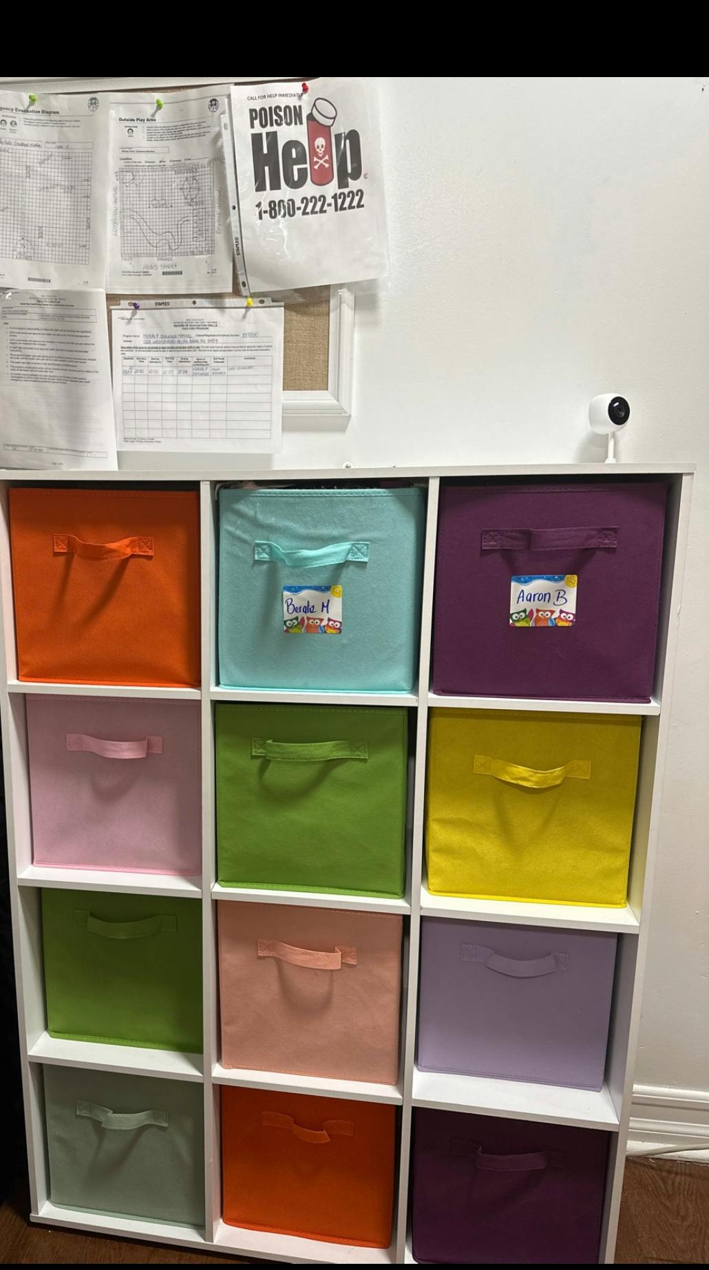 White shelving unit with colorful fabric storage bins