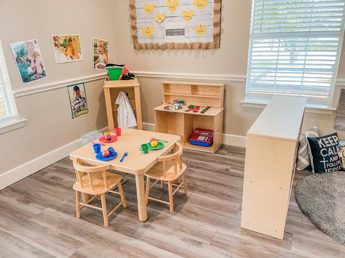Play table with toy food and chairs in a children's classroom