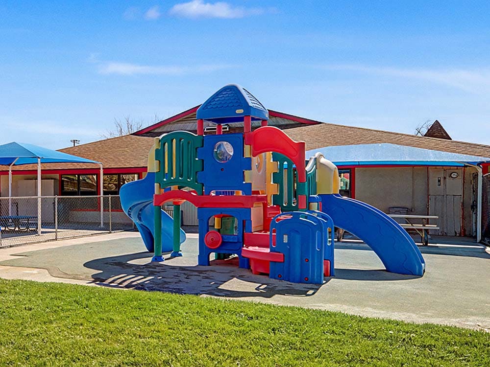 Colorful playground structure with slides on a sunny day