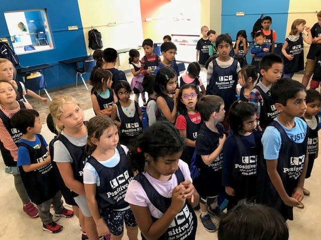 Group of children standing in a room