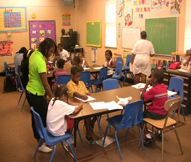 Adults and children in a classroom