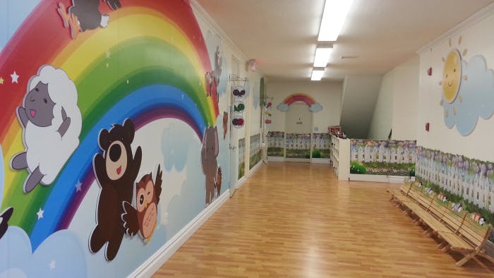 Hallway with cartoon animals and rainbow painted on the wall