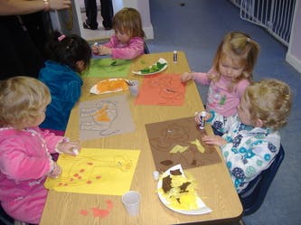 Children doing crafts at a table
