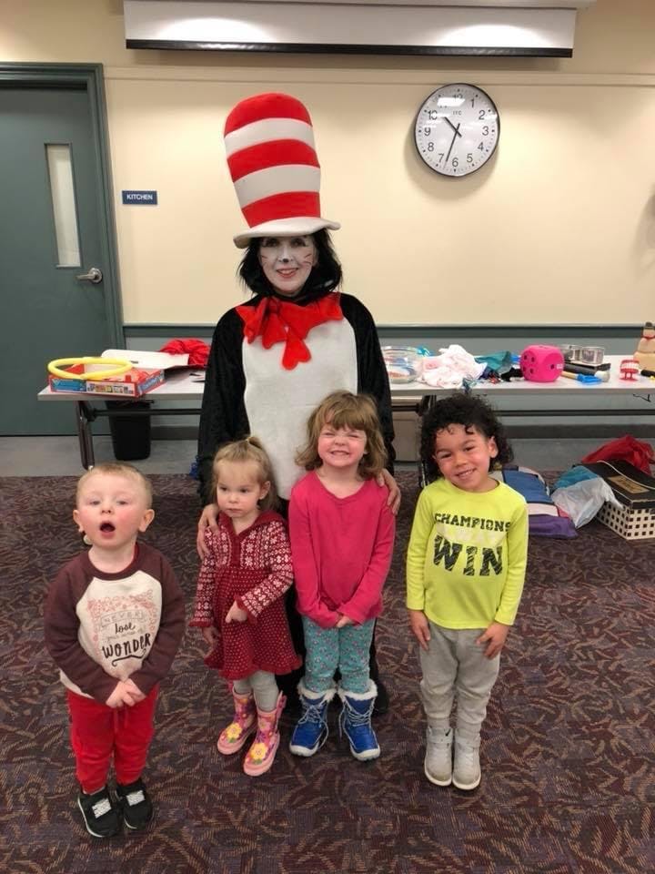 Person in Cat in the Hat costume with four children