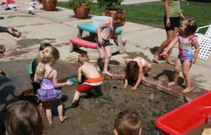 Children playing in a muddy sandbox