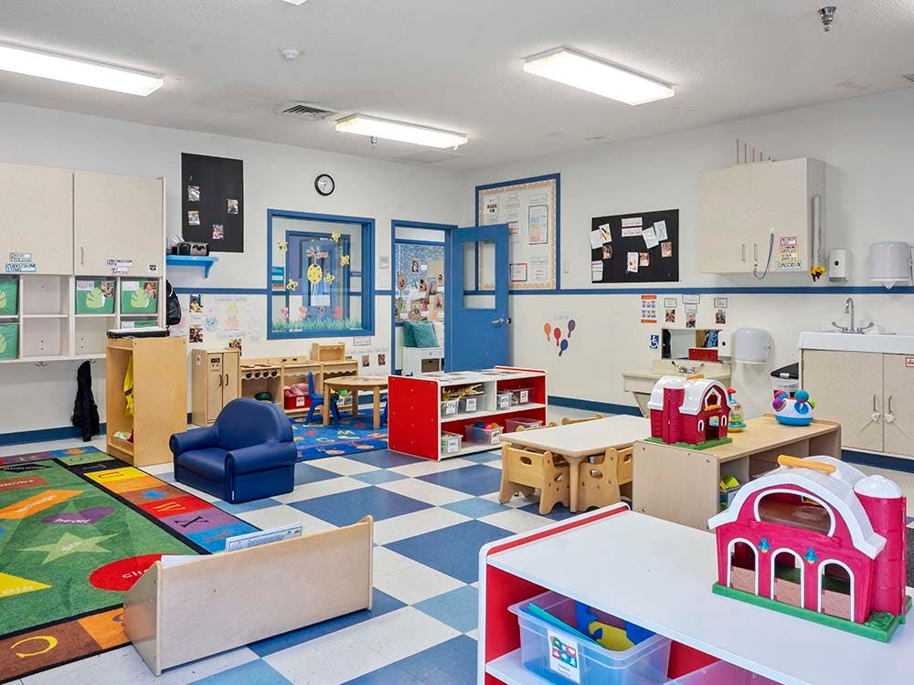 Classroom with child-sized furniture and a blue and white checkered floor