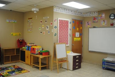 Classroom with a whiteboard, easel, and various learning materials